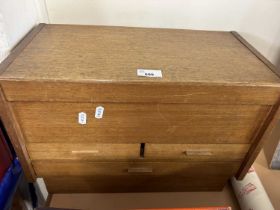 A wooden desk top stationery box