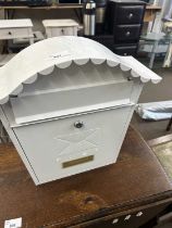 A white metal post box