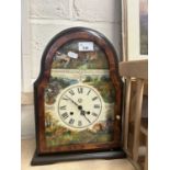 A modern mantel clock decorated with country scenes