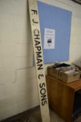 A painted wooden sign for F J Chapman & Son
