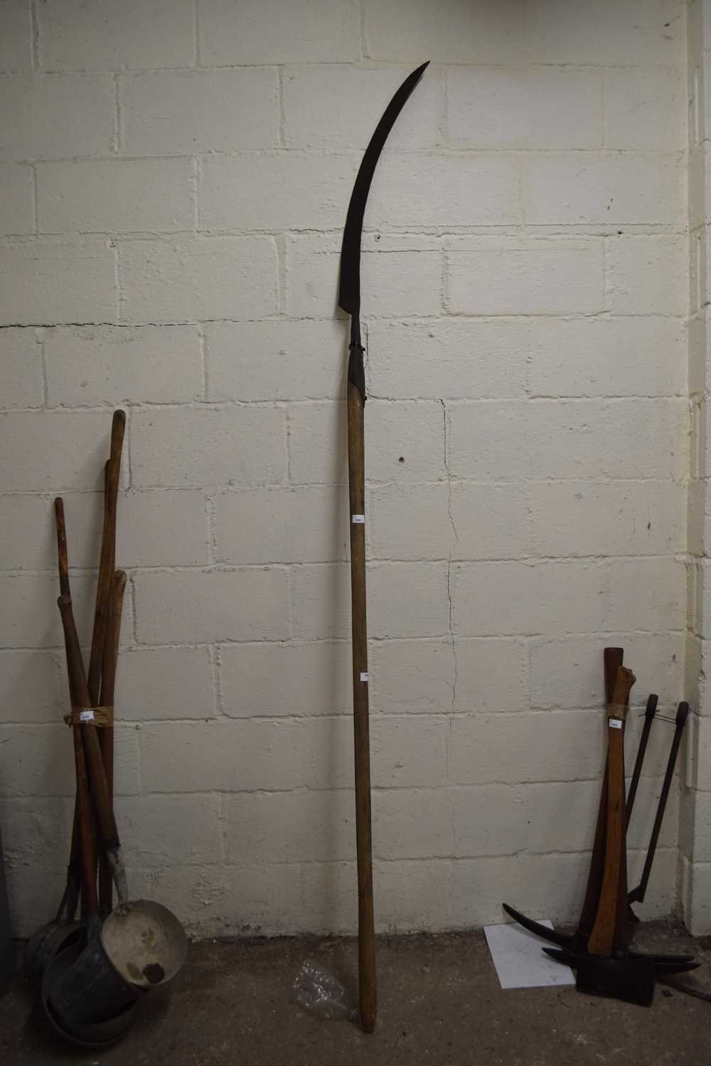 An extra long handle sickle