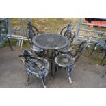 Cast metal garden dining set to include a table and four chairs