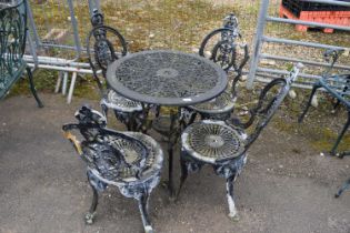 Cast metal garden dining set to include a table and four chairs