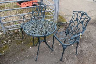 Cast bistro set comprising two chairs and a table