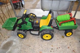 A child's ride on tractor with trailer, branded John Deere