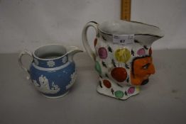 19th Century Jester jug together with a further wooden Calway jug (2)