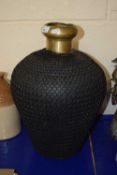 A contemporary mesh mounted brass vase