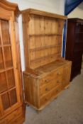 A Victorian and later pine dresser with shelved back with base and three drawers and three doors,