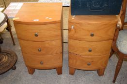 A pair of pine bow front bedside cabinets