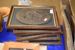 A set of eight bronze effect framed wall plaques