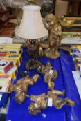 Group of various cherub models and a table lamp