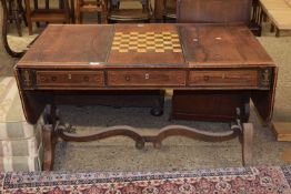 A Georgian rose wood and brass inlaid sofa table with reversible games centre section, sold for