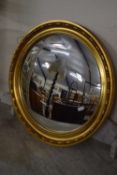 A modern porthole style mirror in gilt frame