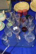 A tray of 19th Century and later drinking glasses to include cranberry glass examples, later