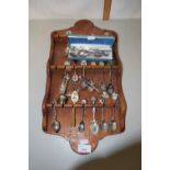 Collection of various crested collectors spoons and wall rack
