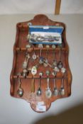 Collection of various crested collectors spoons and wall rack