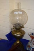 Brass based oil lamp with frosted glass shade