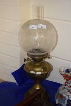 Brass based oil lamp with frosted glass shade