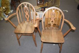 A pair of Ercol carver chairs with Prince of Wales feathers to the backs