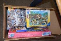 A box of various board games, puzzles etc
