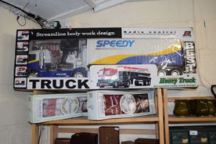 A radio control streamline body heavy truck together with two modern collectors dolls (3)