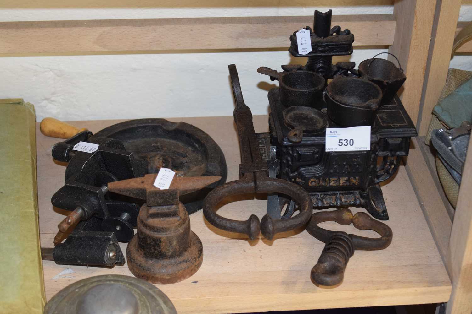Miniature model of iron cooking range together with vintage bull leaders, miniature anvil and