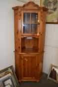 A modern pine corner cabinet