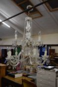 A 20th Century crystal glass chandelier with scrolled arms
