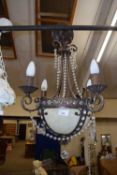 A 20th Century bronzed metal four branch light fitting with glass drapes