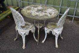A cast metal garden bistro set consisting of a table and two chairs