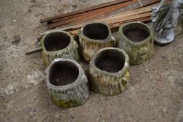 Five composite planters formed as tree stumps