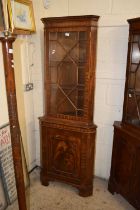 A mahogany veneered corner display cabinet