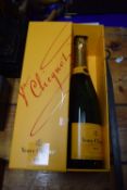 A cased bottle of Veuve Clicquot Brut Champagne and a further related book (2)