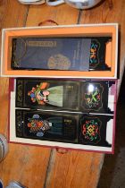 A boxed pair of modern Chinese table screens decorated with scenes of facial make-up of the Peking