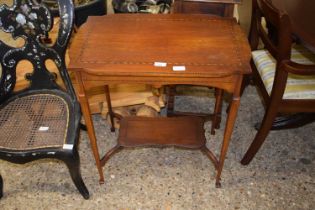 An Edwardian mahogany two tier occasional table