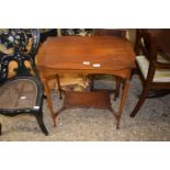 An Edwardian mahogany two tier occasional table