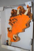 A South African pottery wall plaque formed as a lady in orange dress