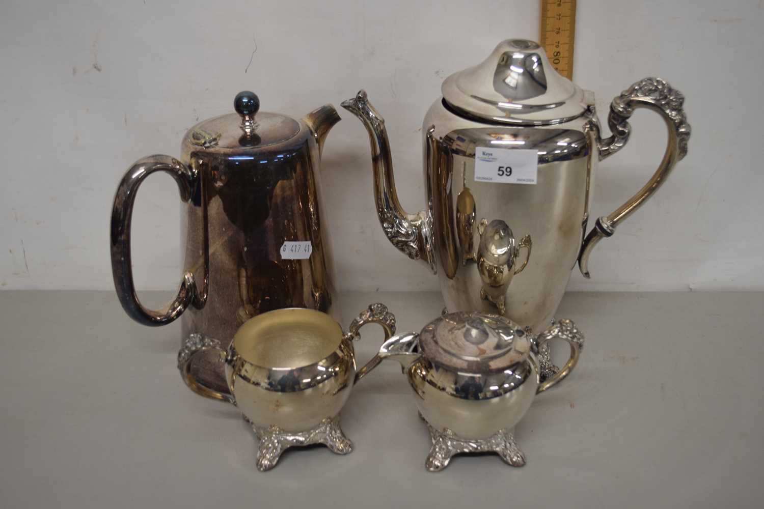 A silver plated tea set and non matching hot water jug