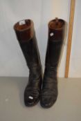 A pair of vintage leather riding boots