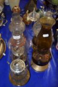 A group of various small oil lamps, glass elephant and other items
