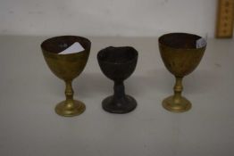 An antique pewter egg cup together with two brass egg cups, possibly 18th Century (3)