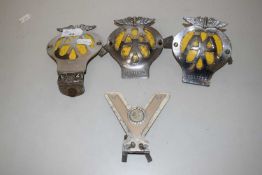 A group of vintage AA car badges and others