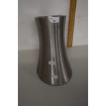 An Andrew James polished steel vase