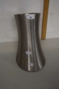 An Andrew James polished steel vase