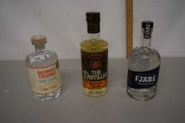 Three bottles of gin comprising Narrow Track Dog Days, The Distiller Rhubarb and Ginger, Fjar Rare