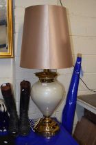 A large modern table lamp with tapering shade
