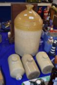 A large unbranded stone ware flagon and three stone ware hot water bottles (4)