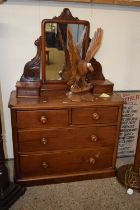 A Victorian mahogany dressing chest with mirrored back and four drawer base