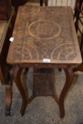 An early 20th Century carved two tier occasional table