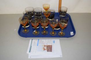 A set of six Stratford amber hock glasses together with a quantity of smoked glass tumblers